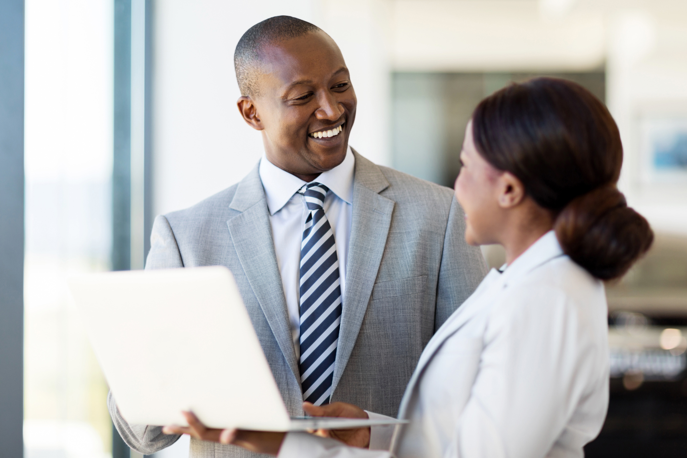 african vehicle dealership principal and saleswoman